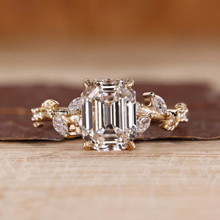 Nature inspired engagement ring with emerald old European cut centre.
