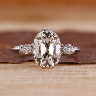 Cushion Old European Cut Ring with round side stones.
