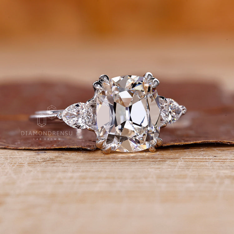 Cushion Old European Cut Ring elegant three stone style.
