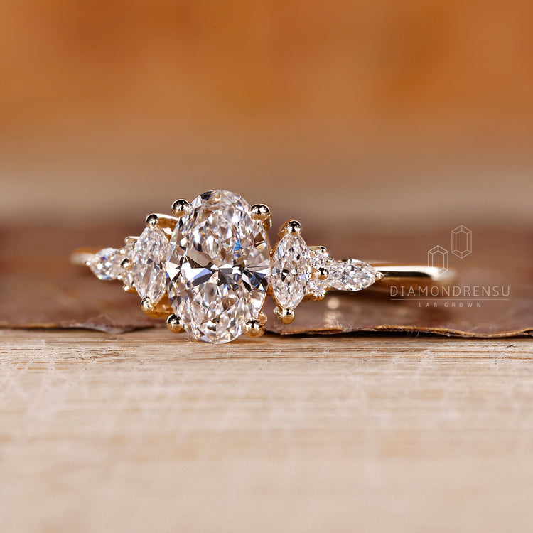 Oval diamond ring marquise round stones prong set.
