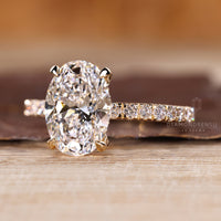 Oval diamond ring with pave hidden halo setting.

