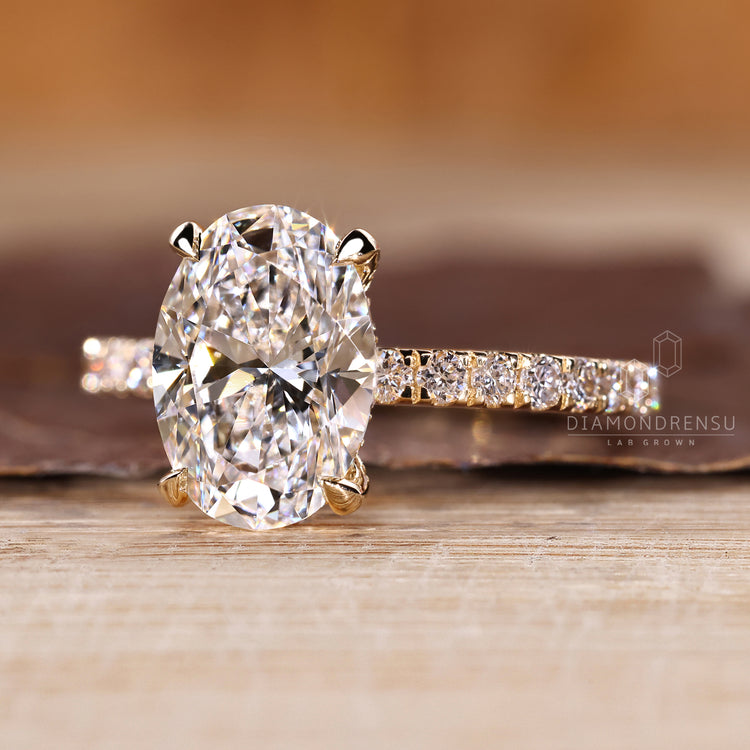 Oval diamond ring with pave hidden halo setting.
