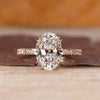 Hidden halo engagement ring with oval cut centre stone.
