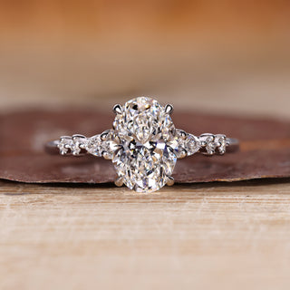 Oval diamond ring pear round side stones cathedral.

