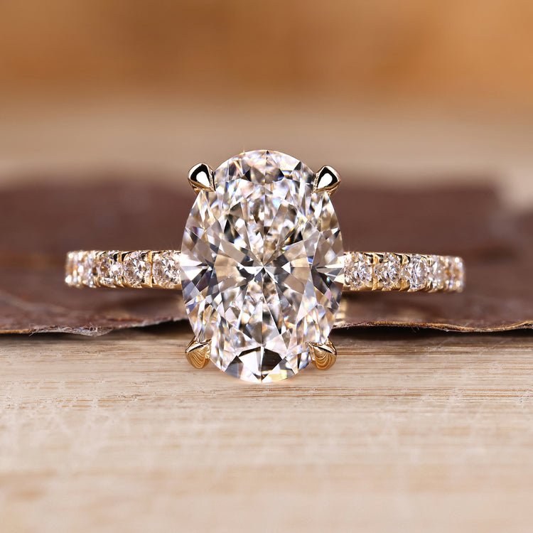 Oval cut diamond ring pave hidden halo four claw set.
