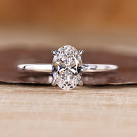Oval diamond engagement ring hidden halo four claw.