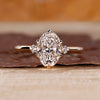 Oval cut diamond ring round side stones three stone.
