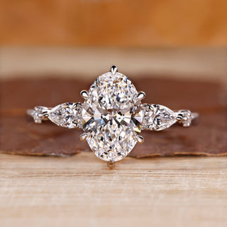 Oval cut diamond ring with pear and round side stones.
