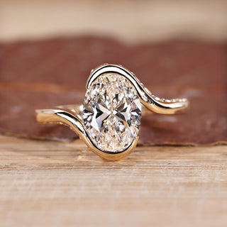 Oval cut diamond ring hidden pave half bezel bypass.