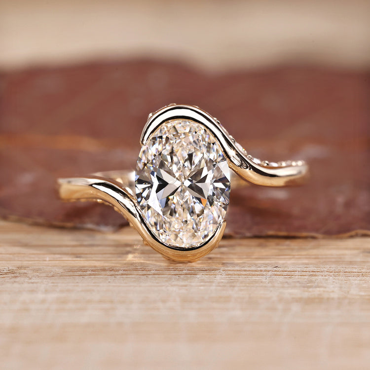 Oval cut diamond ring hidden pave half bezel bypass.