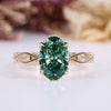 Oval diamond ring with green diamond and side stones.