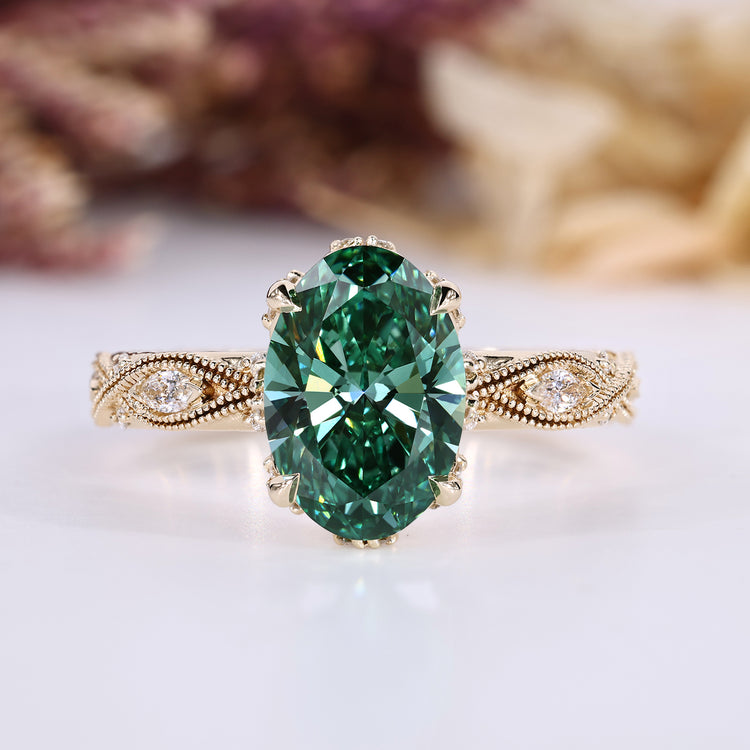 Oval diamond ring with green diamond and side stones.
