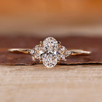 Oval cut diamond ring with round cut side stones.
