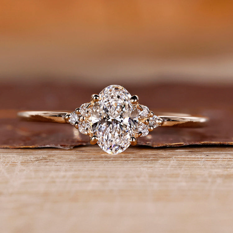 Oval cut diamond ring with round cut side stones.
