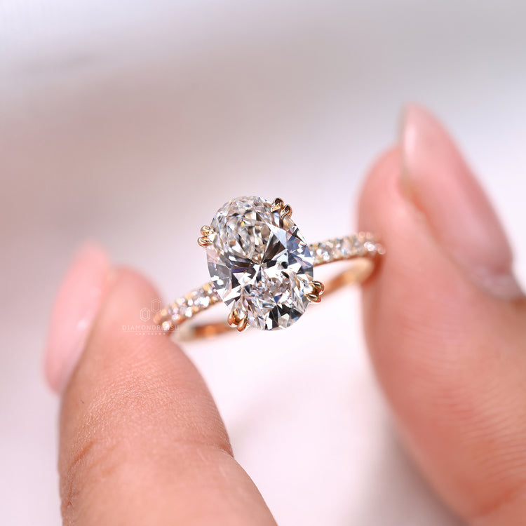 Lab grown oval diamond ring with hidden halo design.
