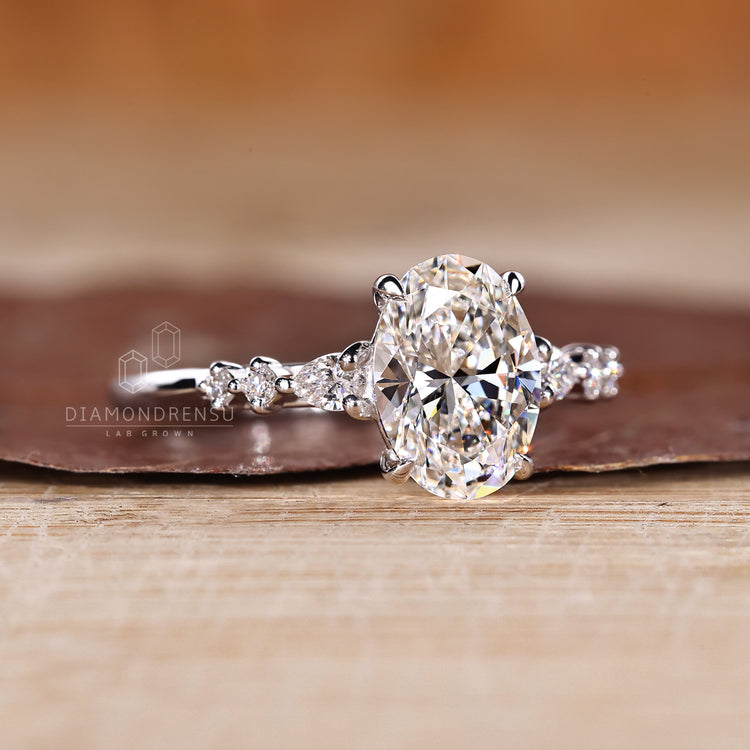 Lab grown oval diamond ring pear round side stones.
