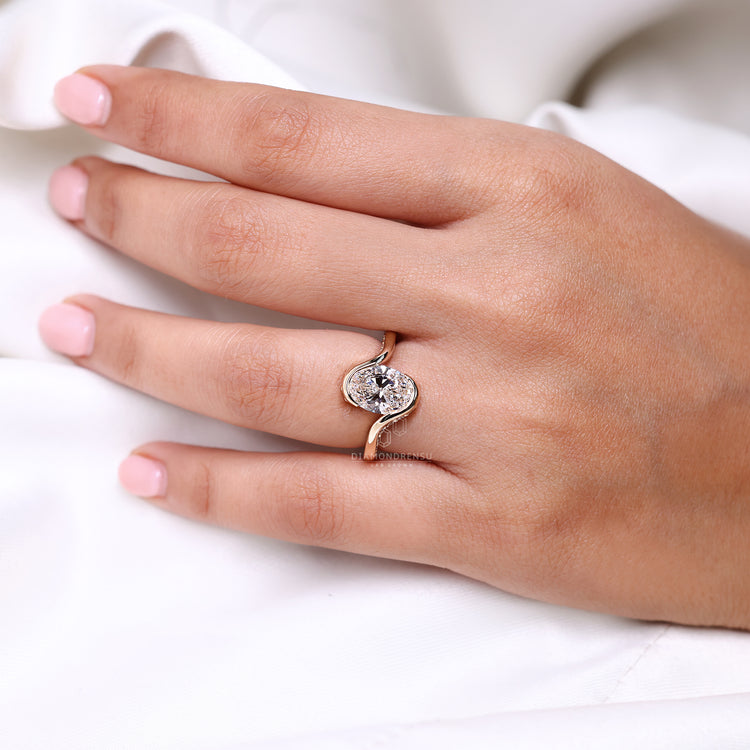 Oval cut ring half bezel bypass hidden pave style.