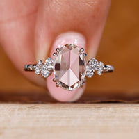 Oval rose cut diamond ring with round cut side stones.
