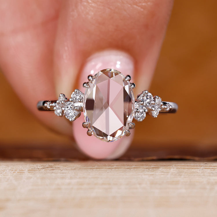 Oval rose cut diamond ring with round cut side stones.
