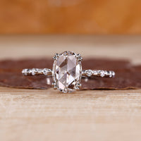 Oval rose cut diamond ring with round hidden stone detail.
