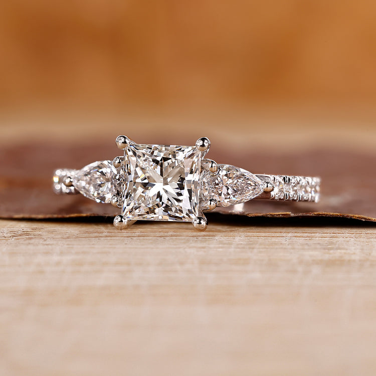 Princess cut diamond engagement ring with pave setting ring.
