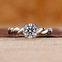 Round cut diamond ring with hidden halo design.
