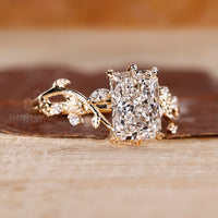 Radiant cut centre diamond ring with organic leaf setting.
