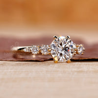 Round side stones used in yellow gold engagement ring.

