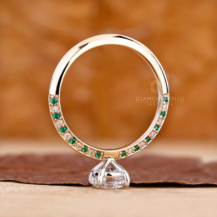Green diamond eternity ring with modern dual tone band.
