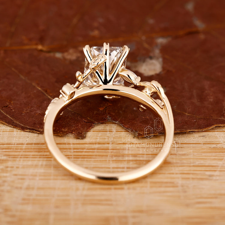 Marquise and round side stone ring in nature motif.
