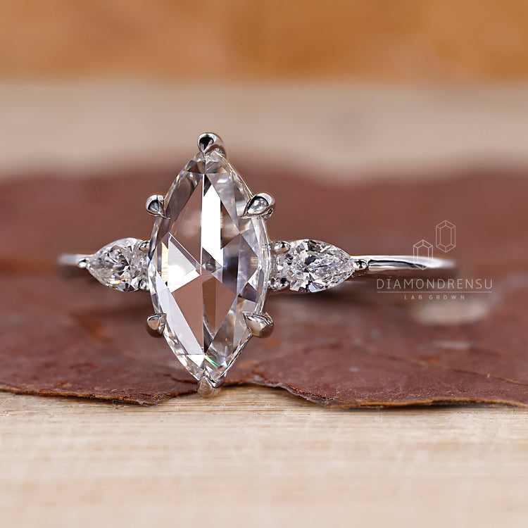 Pear side stones set in 3 stone engagement ring.
