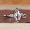 Marquise rose cut engagement ring with pear side stones.
