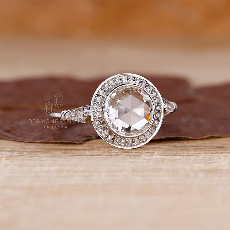 Round rose cut ring set with round side stone.
