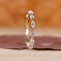 Round diamond wedding band in yellow gold.
