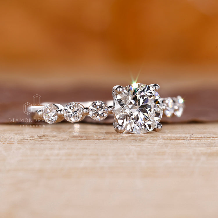 7 stone diamond engagement ring with shared prong setting.
