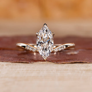Marquise engagement ring with tapered shank band.
