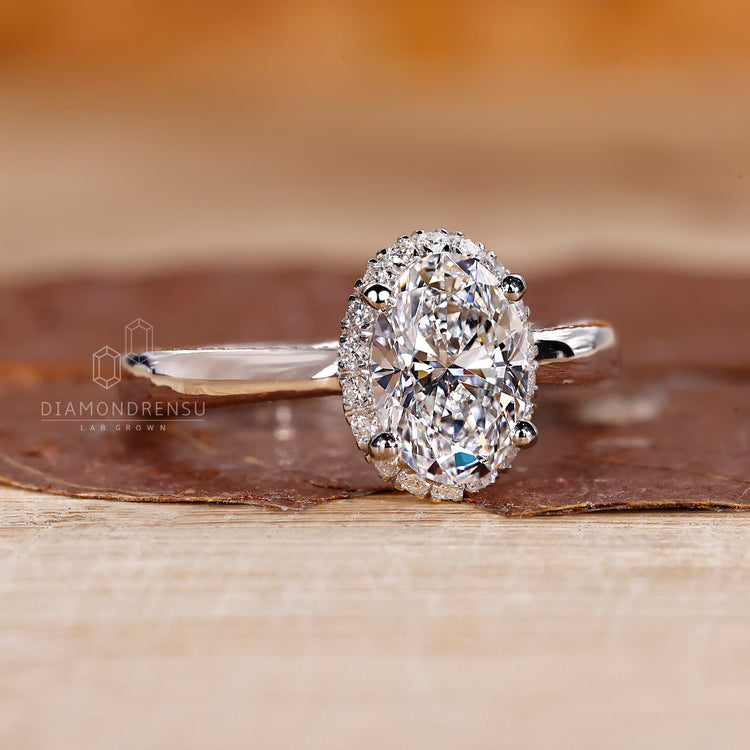 Oval cut diamond ring with tapered shank band.
