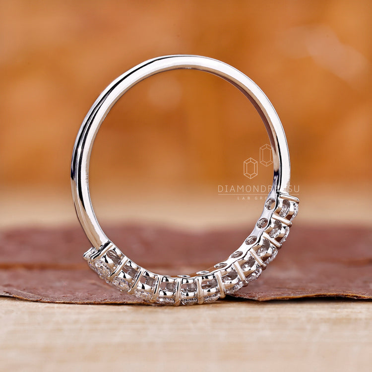 White gold wedding band with oval diamonds.