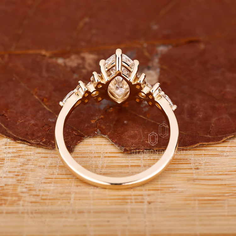Prong Setting Ring with pear and round side accents.

