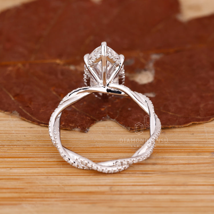 White Gold Ring with twisted band and pave round diamonds.
