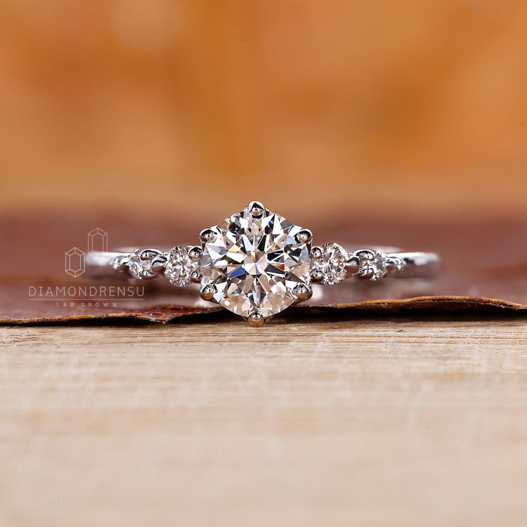 Handmade 5 diamond ring with tapered shank in white gold.
