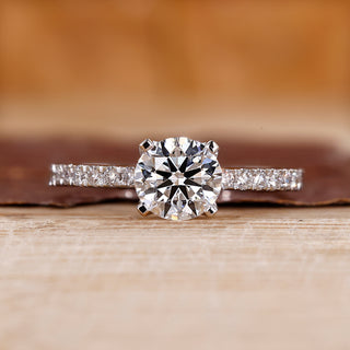 Pave engagement ring with round diamond center.
