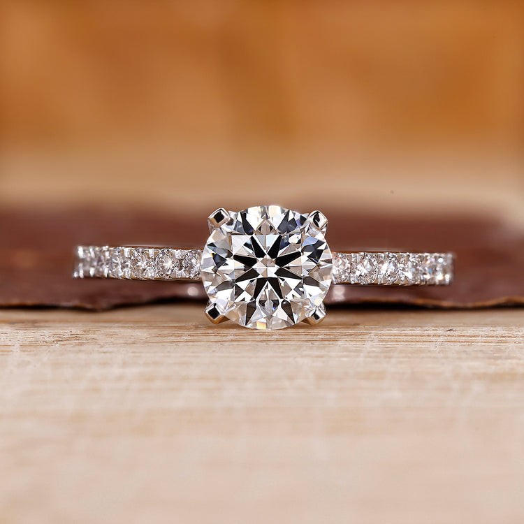 Pave engagement ring with round diamond center.
