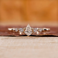 Pear diamond engagement ring with a 5 stone ring.
