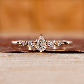 Pear diamond engagement ring with a 5 stone ring.
