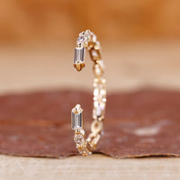 Marquise and baguette wedding band with yellow gold diamond band.