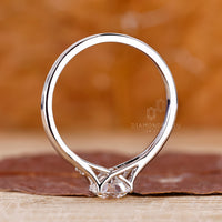 Round cut diamond engagement ring with elegant split band.
