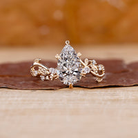Pear shaped engagement ring in yellow gold diamond ring.
