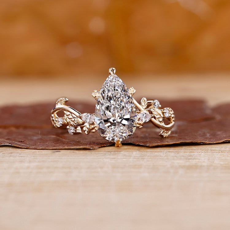 Pear shaped engagement ring in yellow gold diamond ring.
