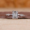 Emerald cut engagement ring with knife edge shank ring.
